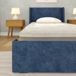 Blue upholstered bed frame with memory foam mattress in modern bedroom setting.