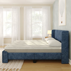Luxurious modern bedroom with comfortable mattress and elegant blue upholstered bed frame.