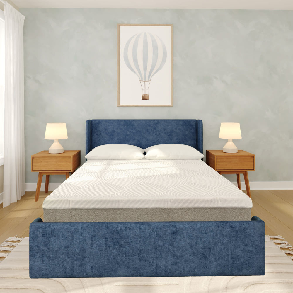 Luxurious modern bedroom with blue upholstered bed, stylish wooden nightstands, and elegant decor.
