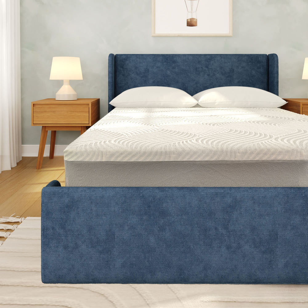Blue upholstered bed frame with white mattress in modern bedroom setting.