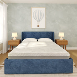 Modern bedroom with blue upholstered bed frame, wooden nightstands, and hot air balloon artwork.