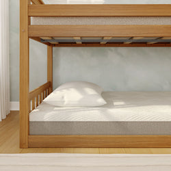 Wooden bunk bed with a comfortable mattress and white pillow in a bright, modern bedroom.