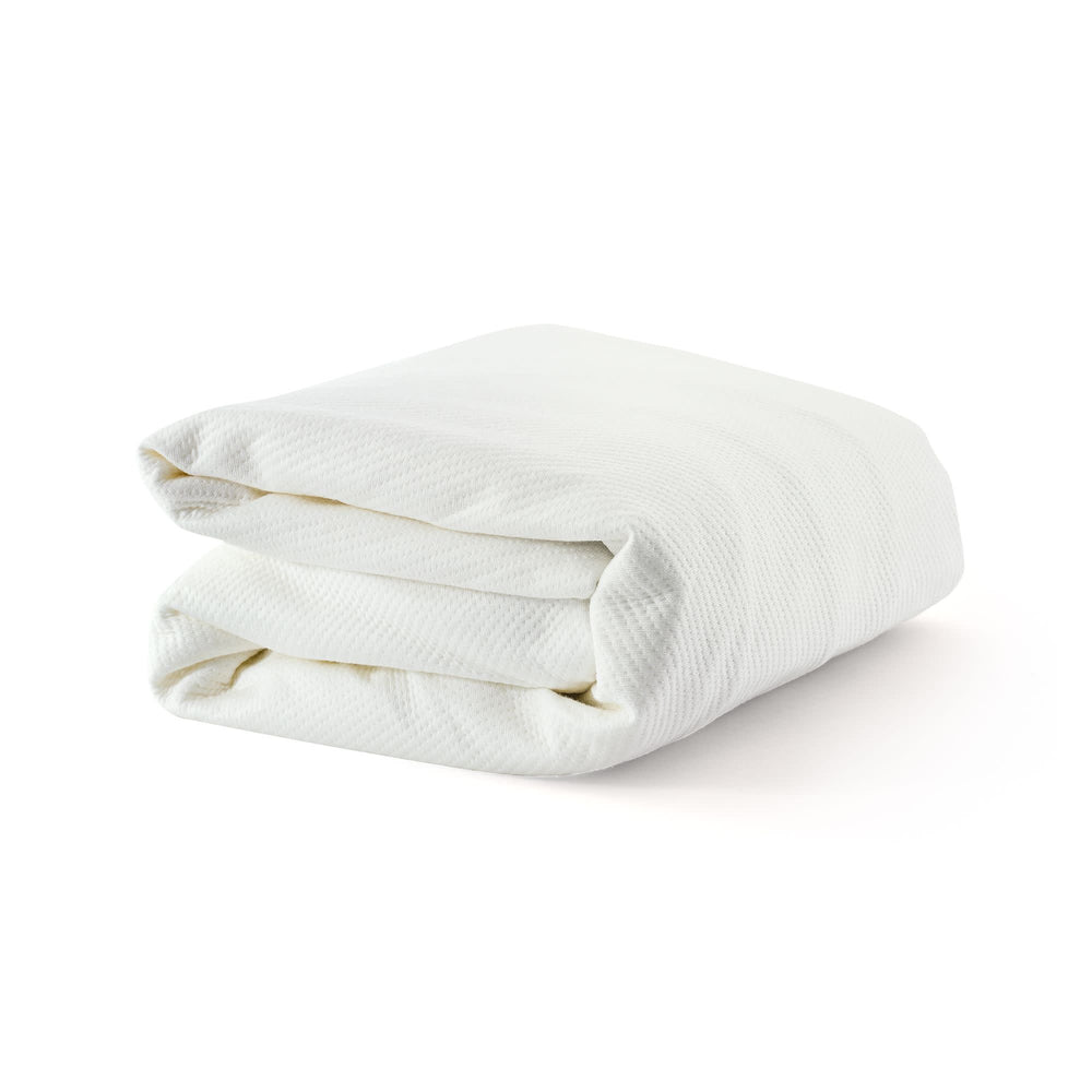 Folded white blanket made of soft, breathable fabric for comfortable bedding.