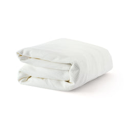 Folded white blanket made of soft, breathable fabric for comfortable bedding.