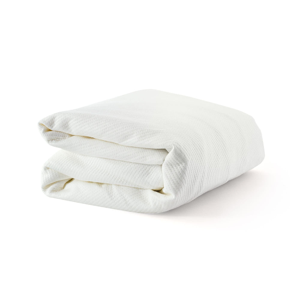 Folded white blanket on a white background, ideal for bedding and home decor.