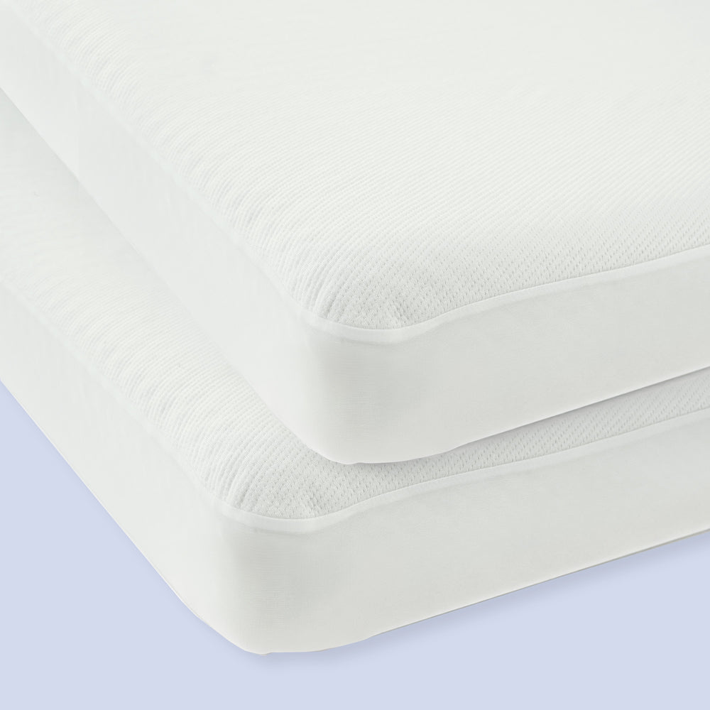 Two white twin mattresses stacked on a light blue background, showcasing comfort and quality bedding options.