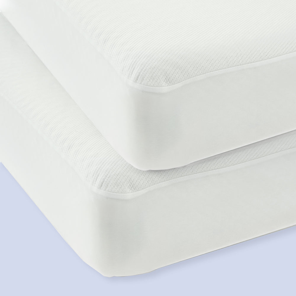 Two stackable white foam mattresses with textured fabric covers.
