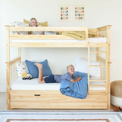Children enjoying a wooden bunk bed with colorful bedding and playful room decor.